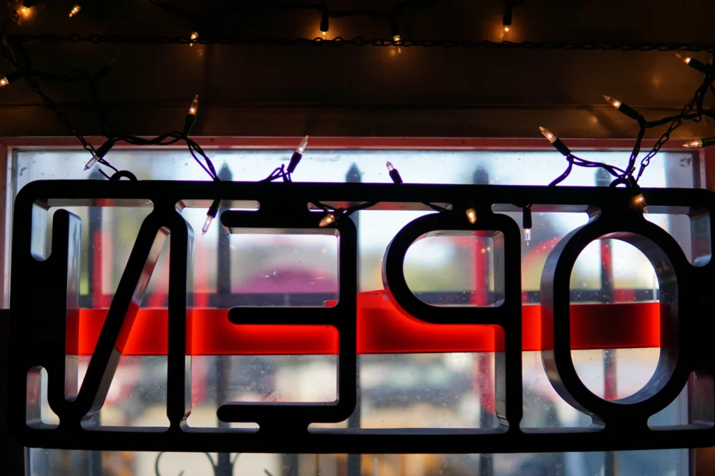 A view from inside the restaurant looking out the front window, where the 'OPEN' sign is visible backwards.